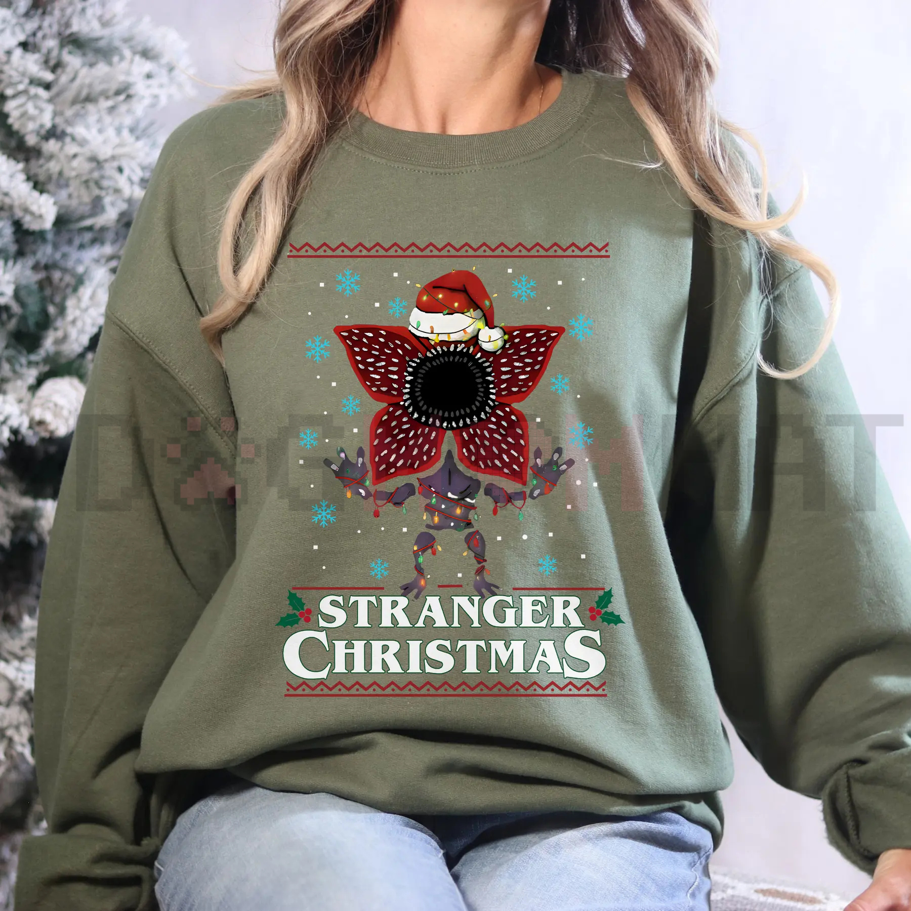 Stranger Christmas sweatshirt, olive green with red and blue festive graphic front