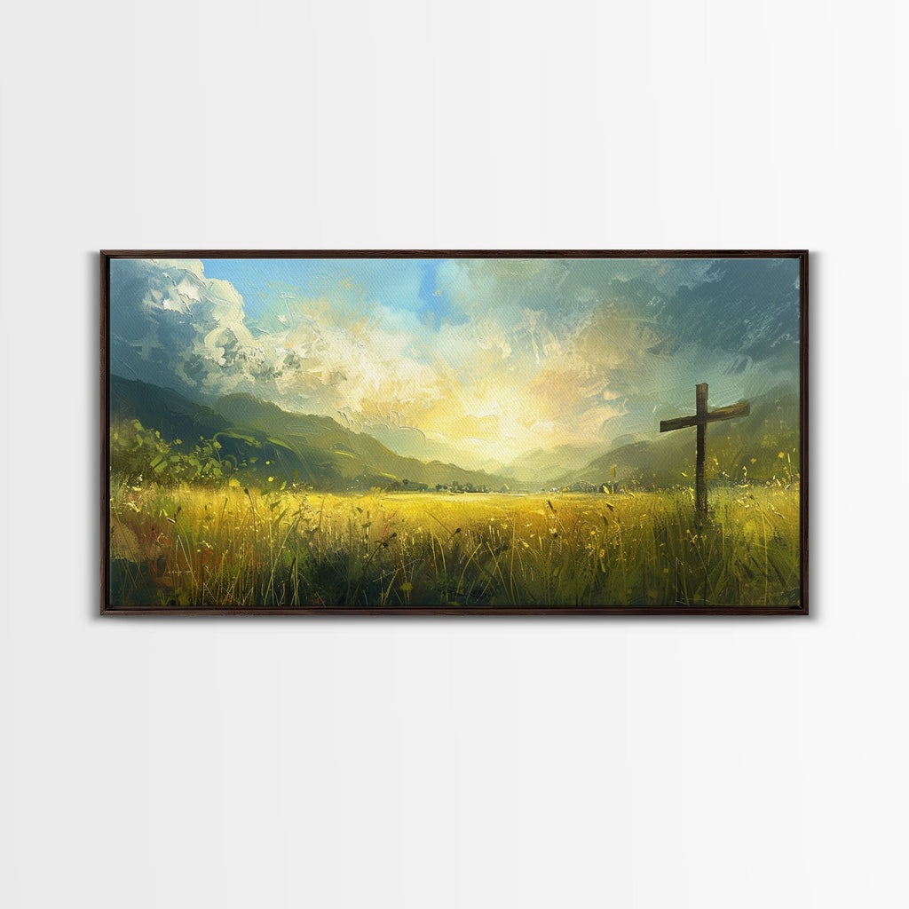 Framed canvas print of a cross standing in tall grass with glowing clouds