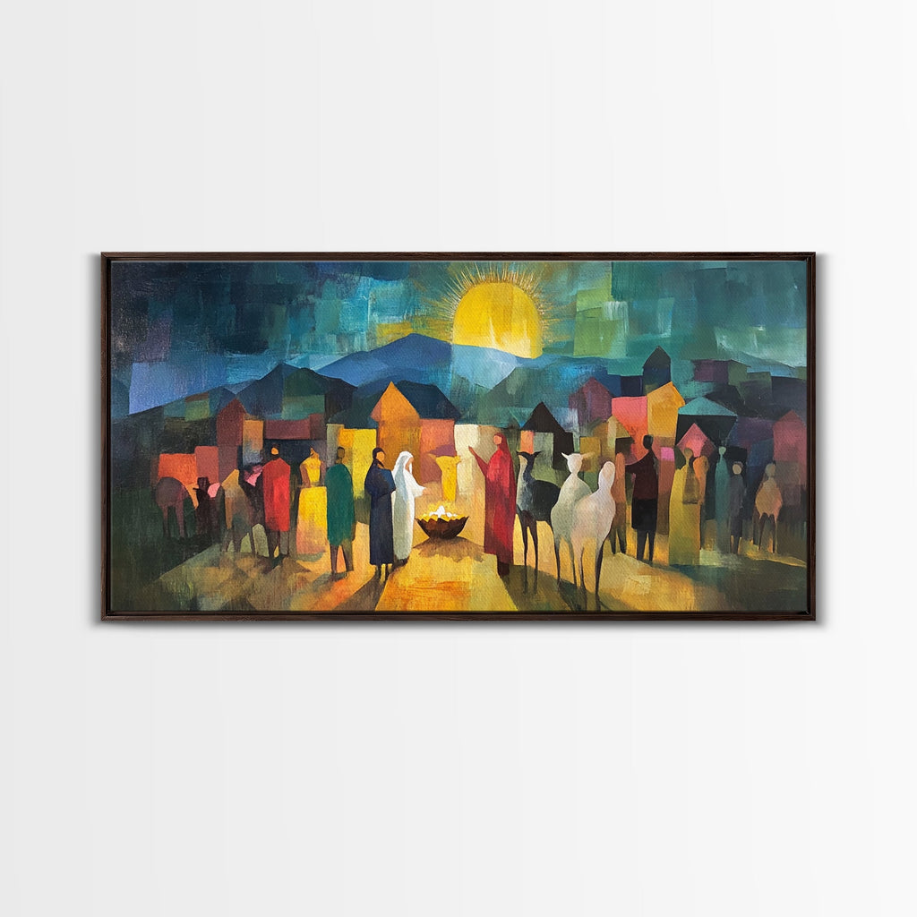 Black-framed nativity scene wall art with crowd of figures and glowing sun above town