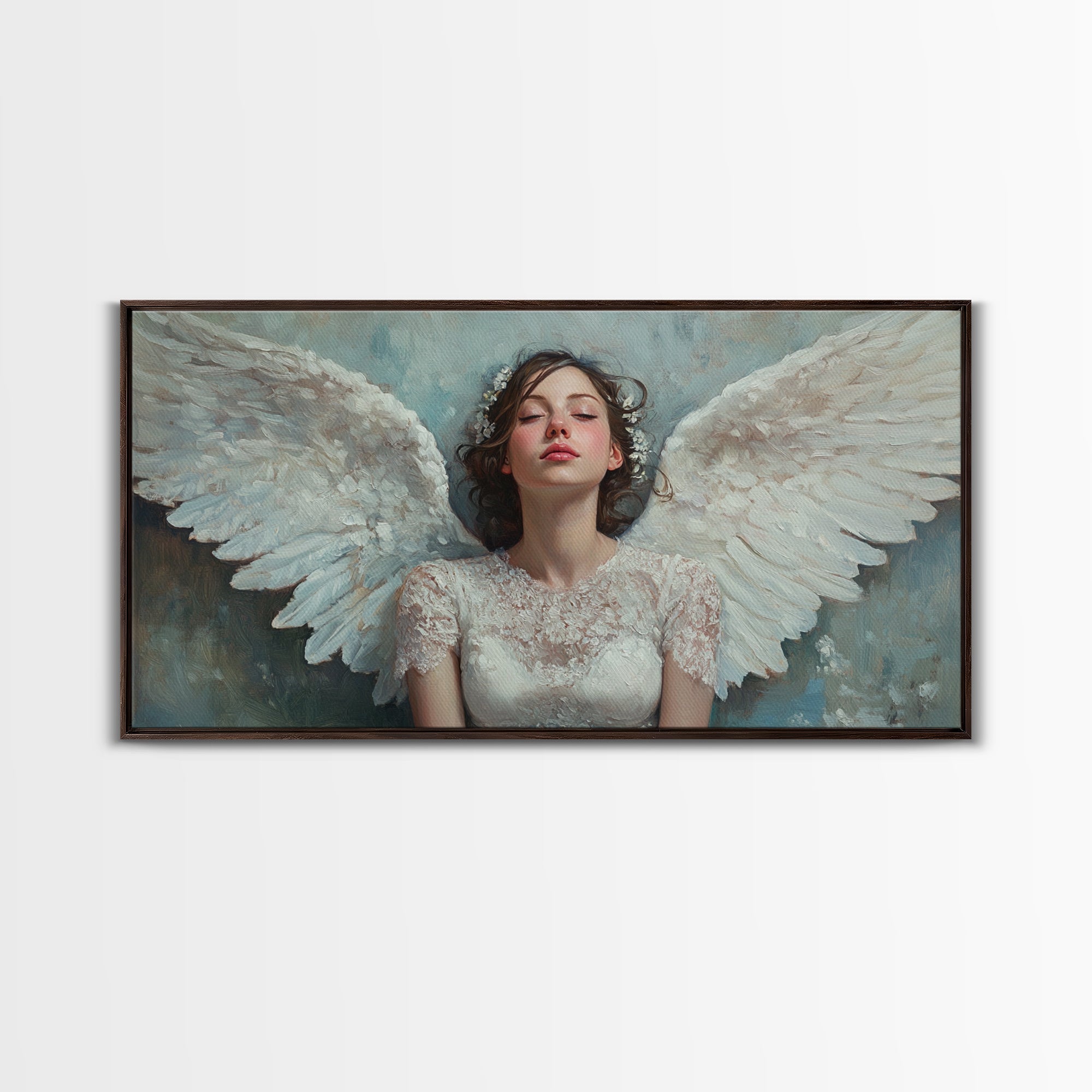 Framed angel canvas print with white wings and pale blue background, black frame