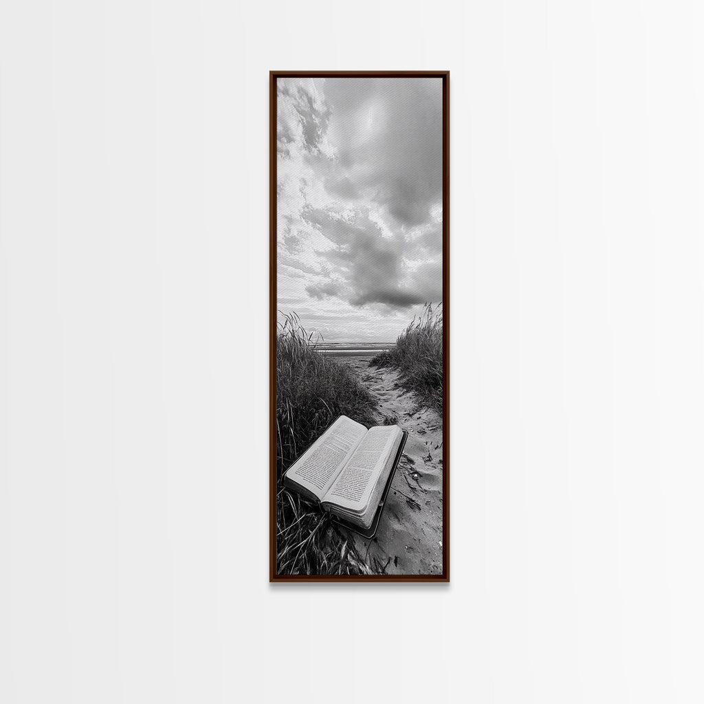 Dark wood framed canvas print of open Bible on a sandy beach path under cloudy sky