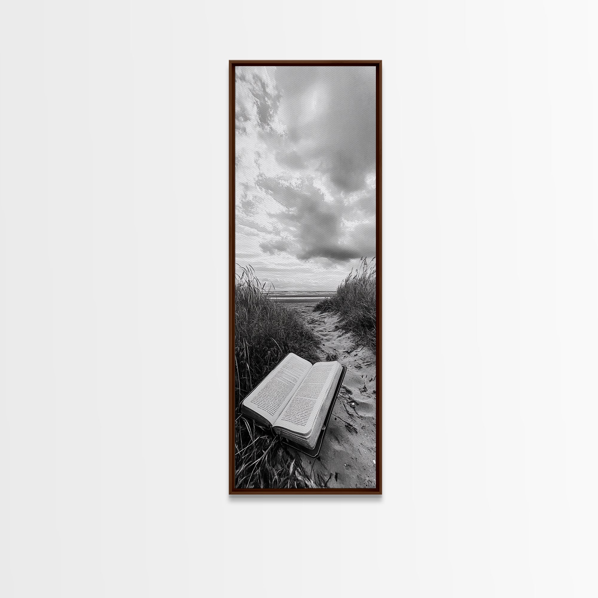 Dark wood framed canvas print of open Bible on a sandy beach path under cloudy sky