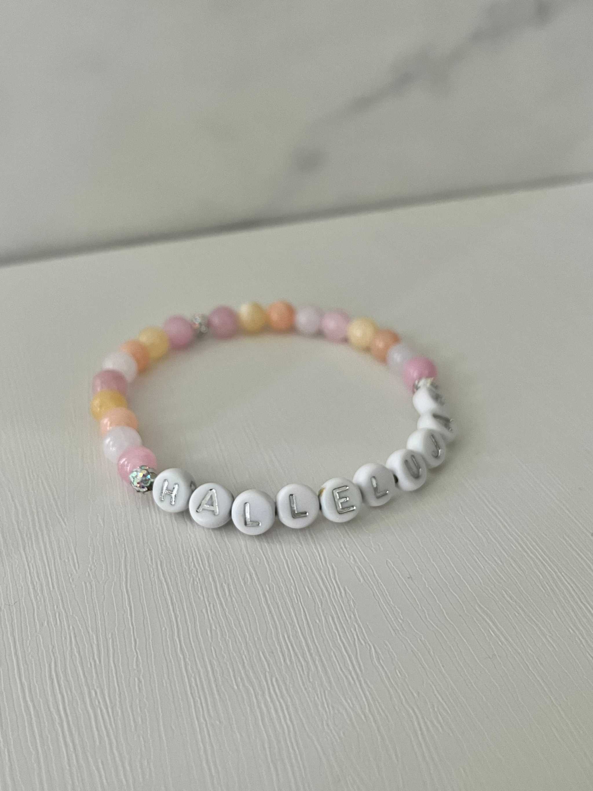 Beaded bracelet with multicolor pastel round beads and silver letter beads spelling HALLELUJAH