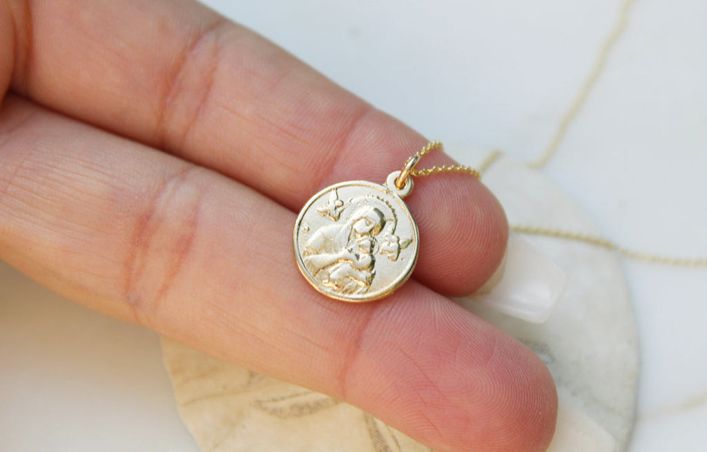 14k gold pendant necklace showing round medallion with Our Lady figure