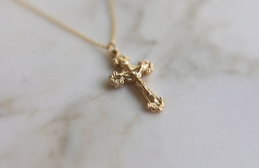 14k gold crucifix pendant on a thin chain, small side profile cross.