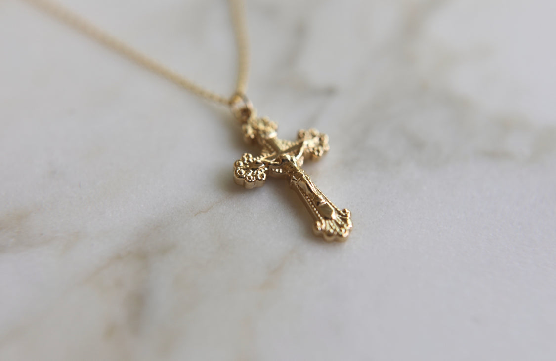 14k gold crucifix pendant on a thin chain, small side profile cross.