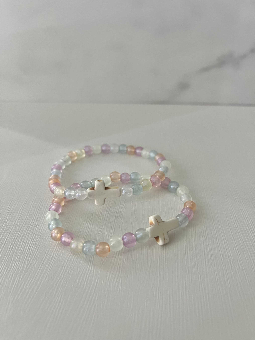 Colorful bead bracelet with pastel beads and small cross charms