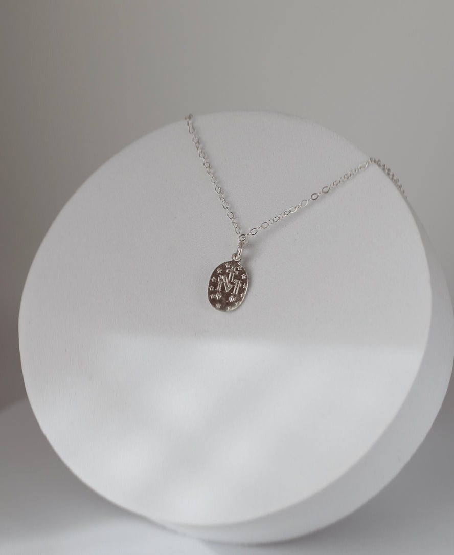 Silver miraculous medal necklace with oval pendant on thin chain