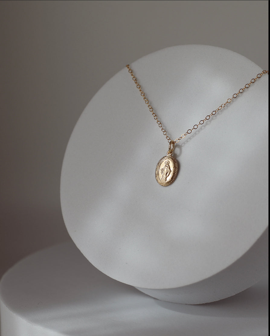 Gold-tone chain necklace with small round medal pendant