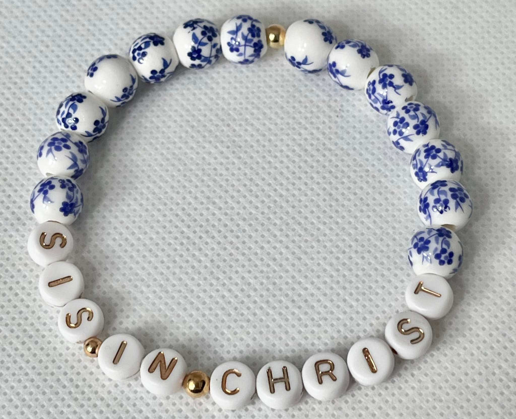 Blue and white bead bracelet with gold spacers and letters spelling IN CHRIST