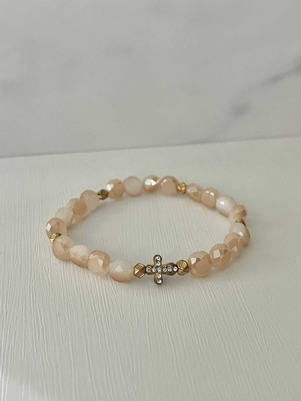 Peach beaded cross bracelet with gold cross charm