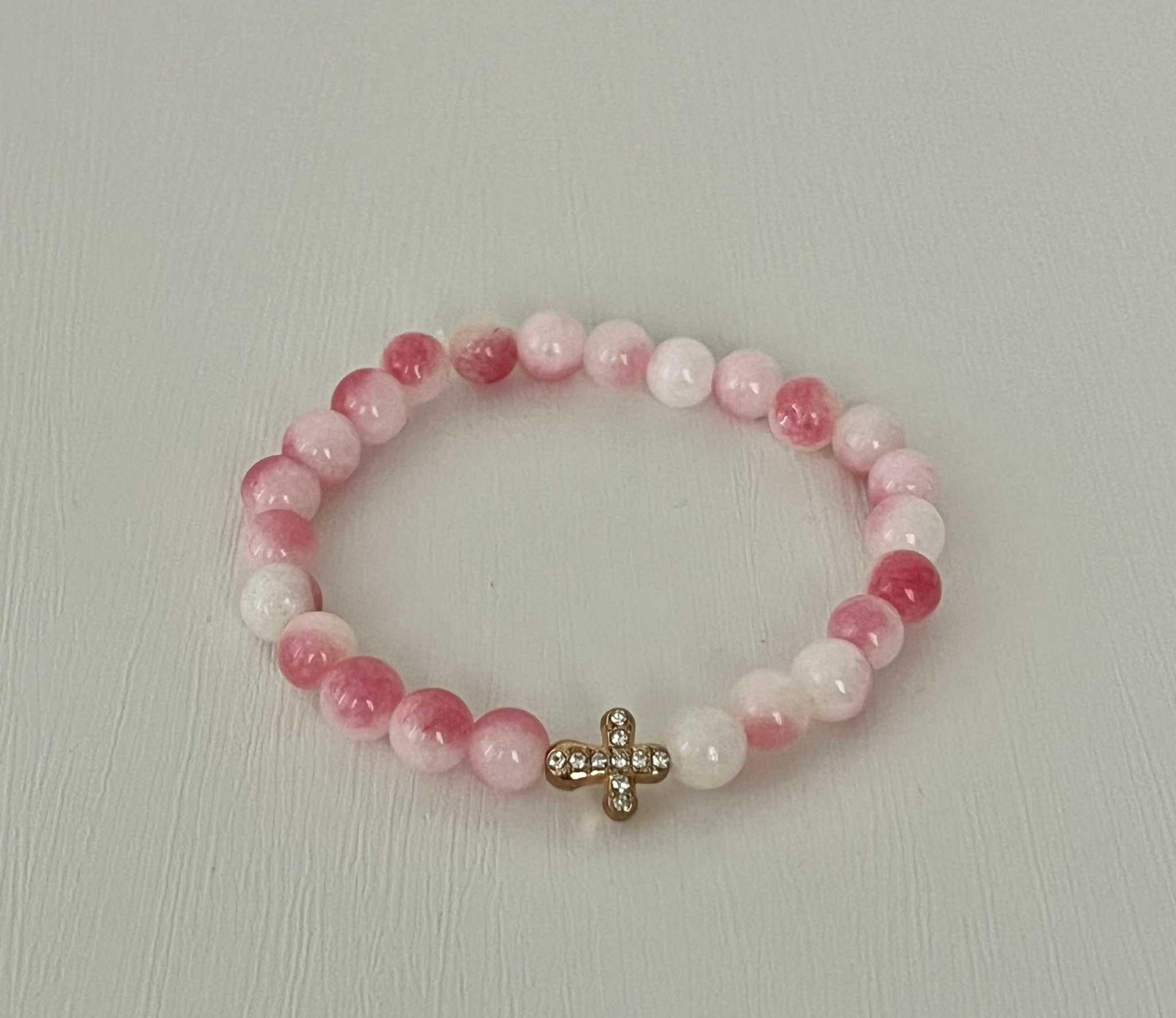 Beaded cross bracelet with pink and translucent beads and rhinestone cross charm