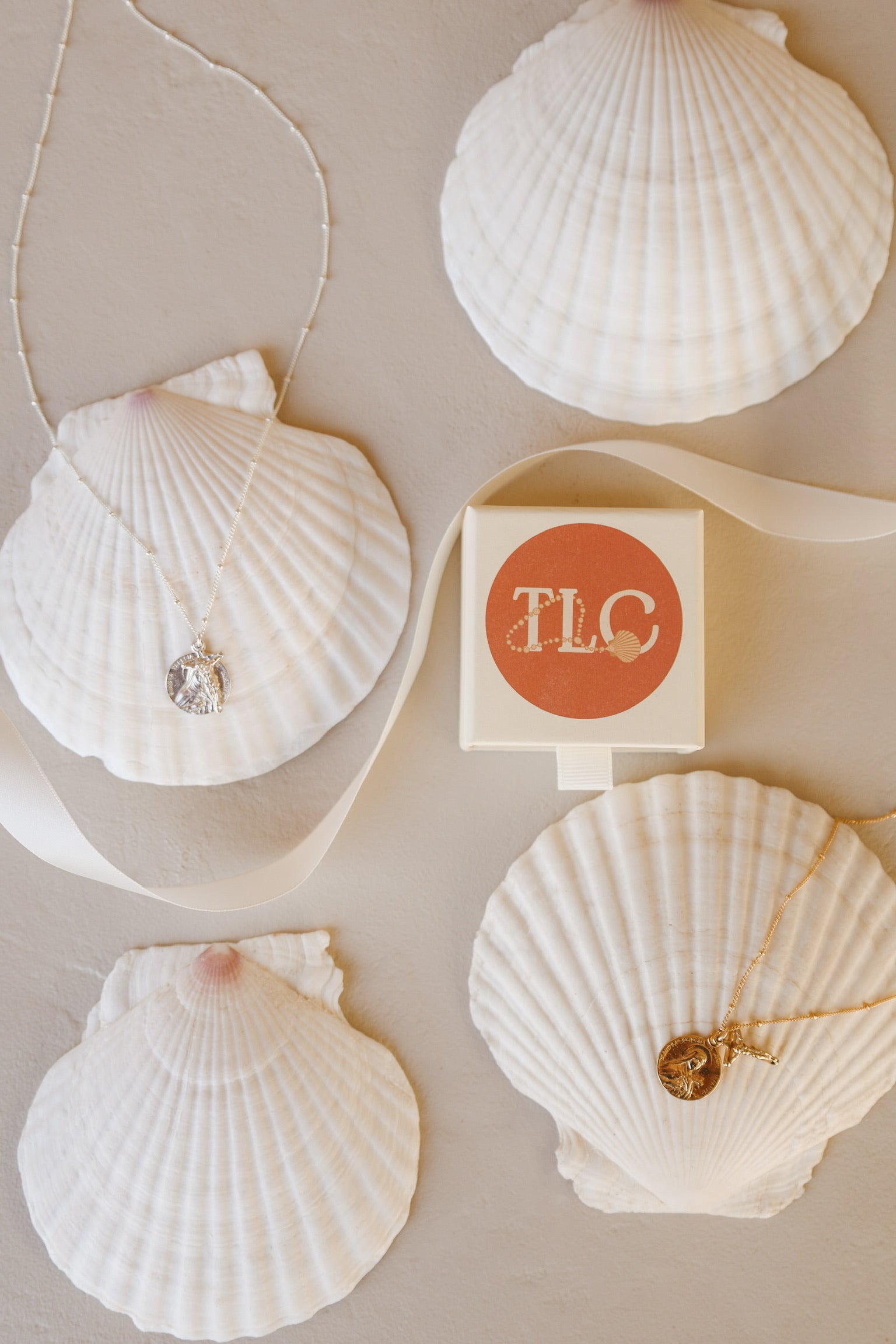 St. Therese of Lisieux crucifix necklace with gold-tone charm on white seashell card