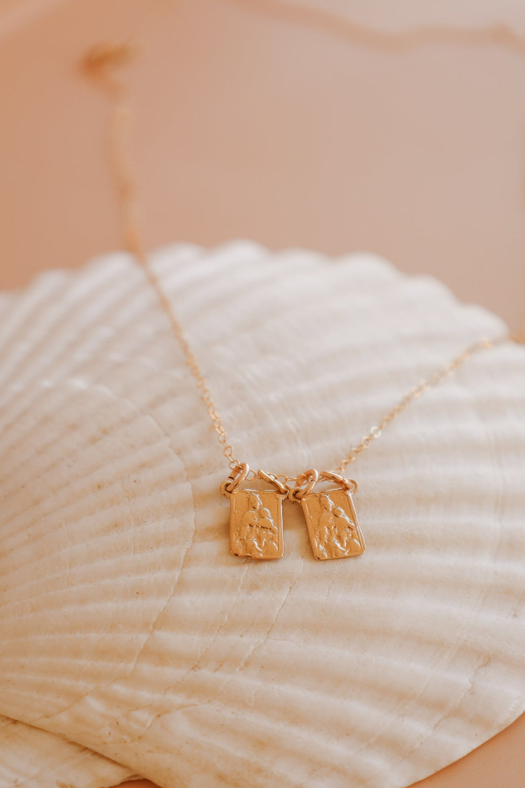 Scapular charm necklace with two rectangular pendant charms on a gold chain