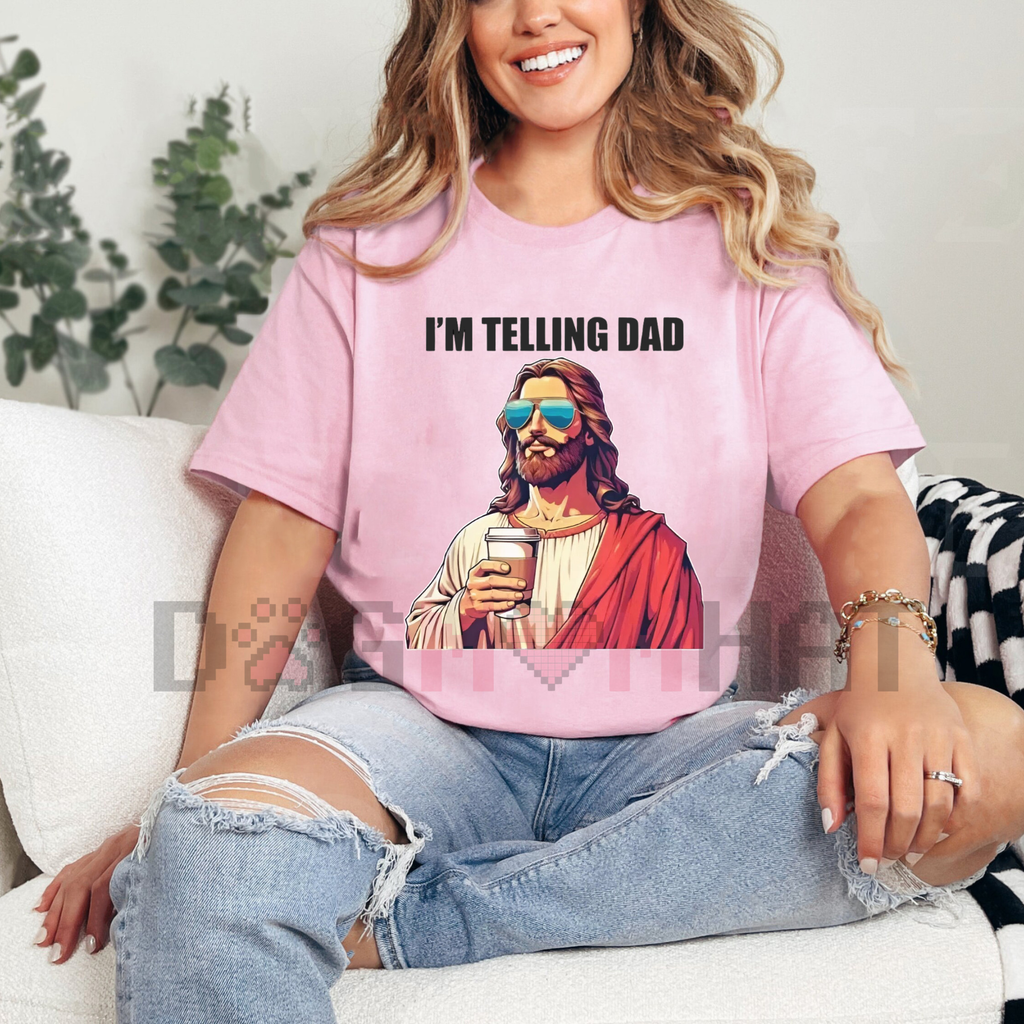 Pink T-shirt with "I'M TELLING DAD" text and Jesus-style graphic in red