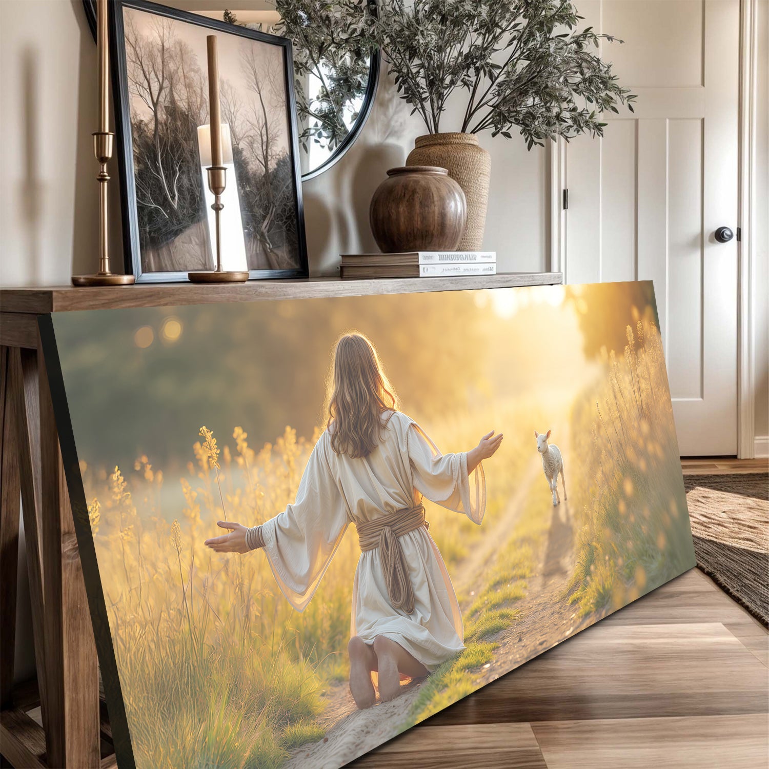 Landscape canvas print on easel showing kneeling woman in white robe with a lamb