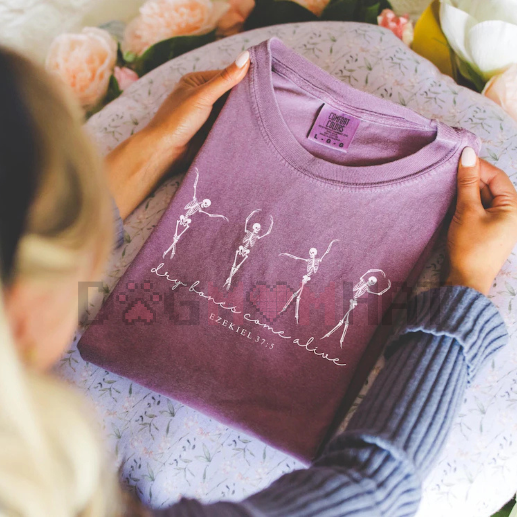 Purple T-shirt with white dancing skeletons and “dry bones come alive” lettering