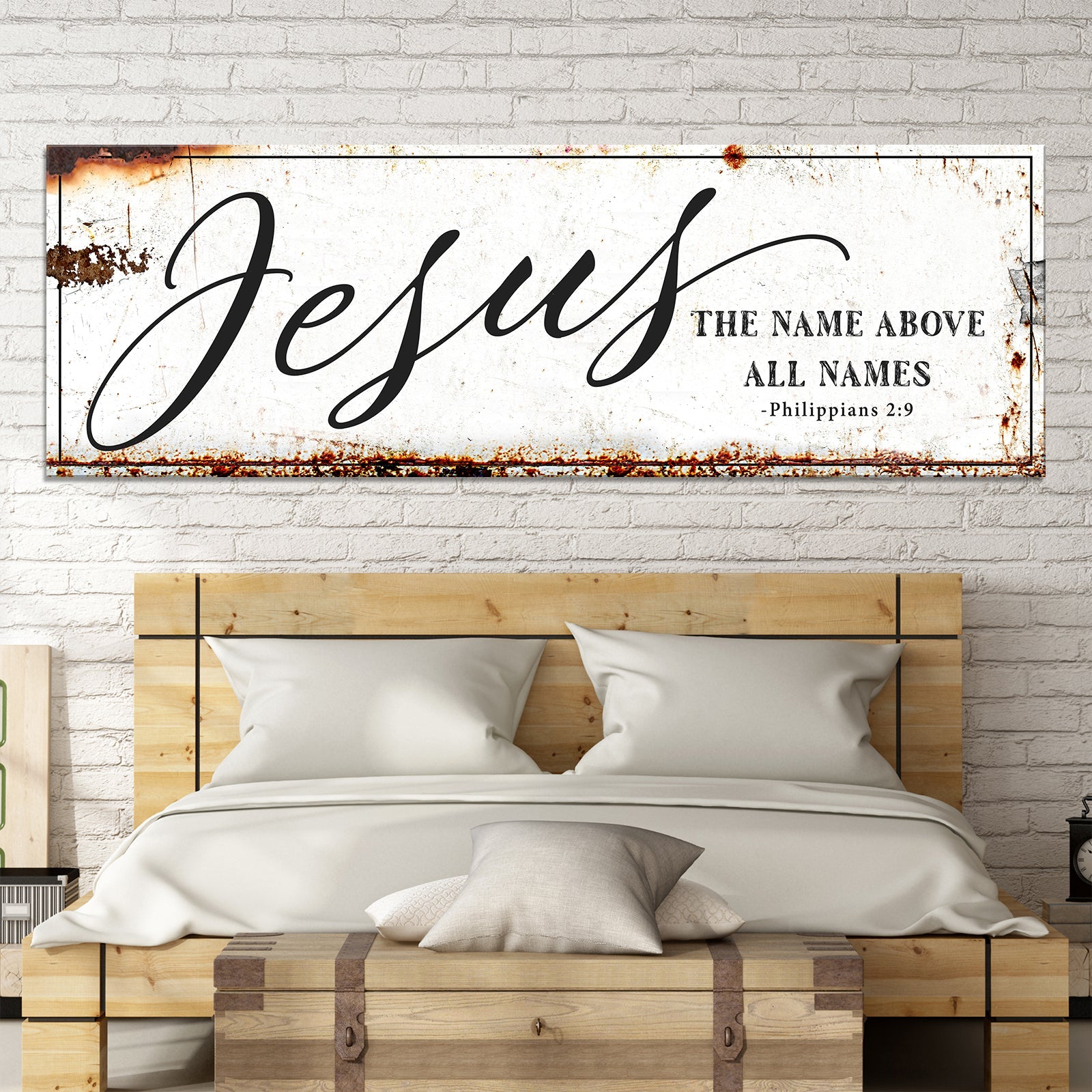 Framed Jesus scripture wall art above bed with 'The name above all names' and 'Philippians 2:9'