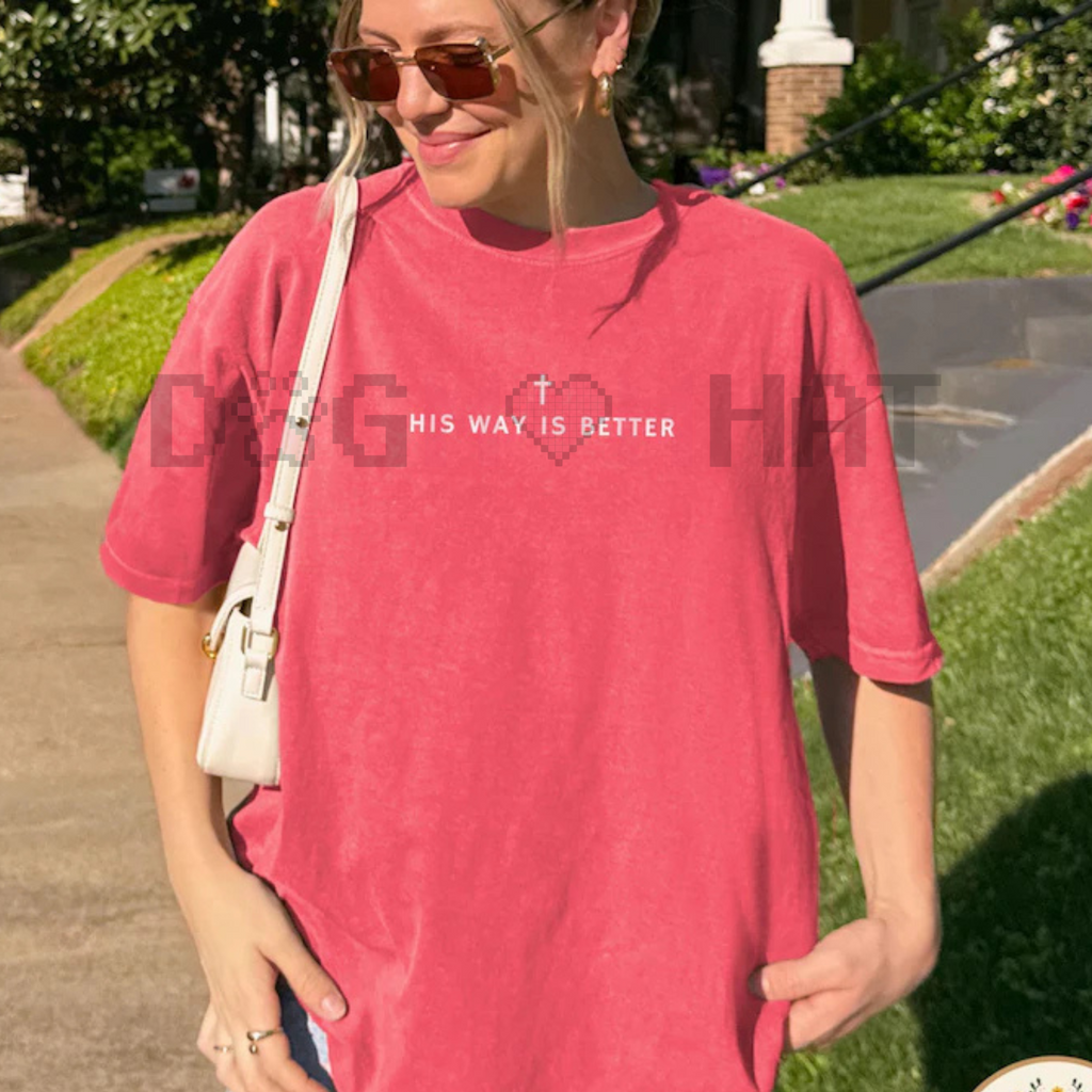 Pink crewneck T-shirt with short sleeves and centered text with cross graphic