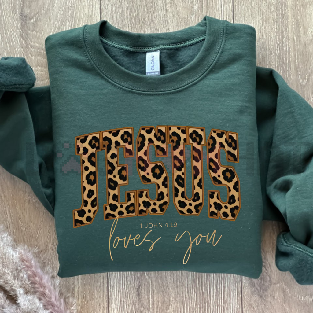 Forest green crewneck sweatshirt with leopard JESUS print and gold love you script.
