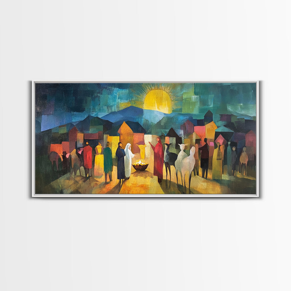 White-framed nativity scene art print with town crowd, glowing sun, and candle in center
