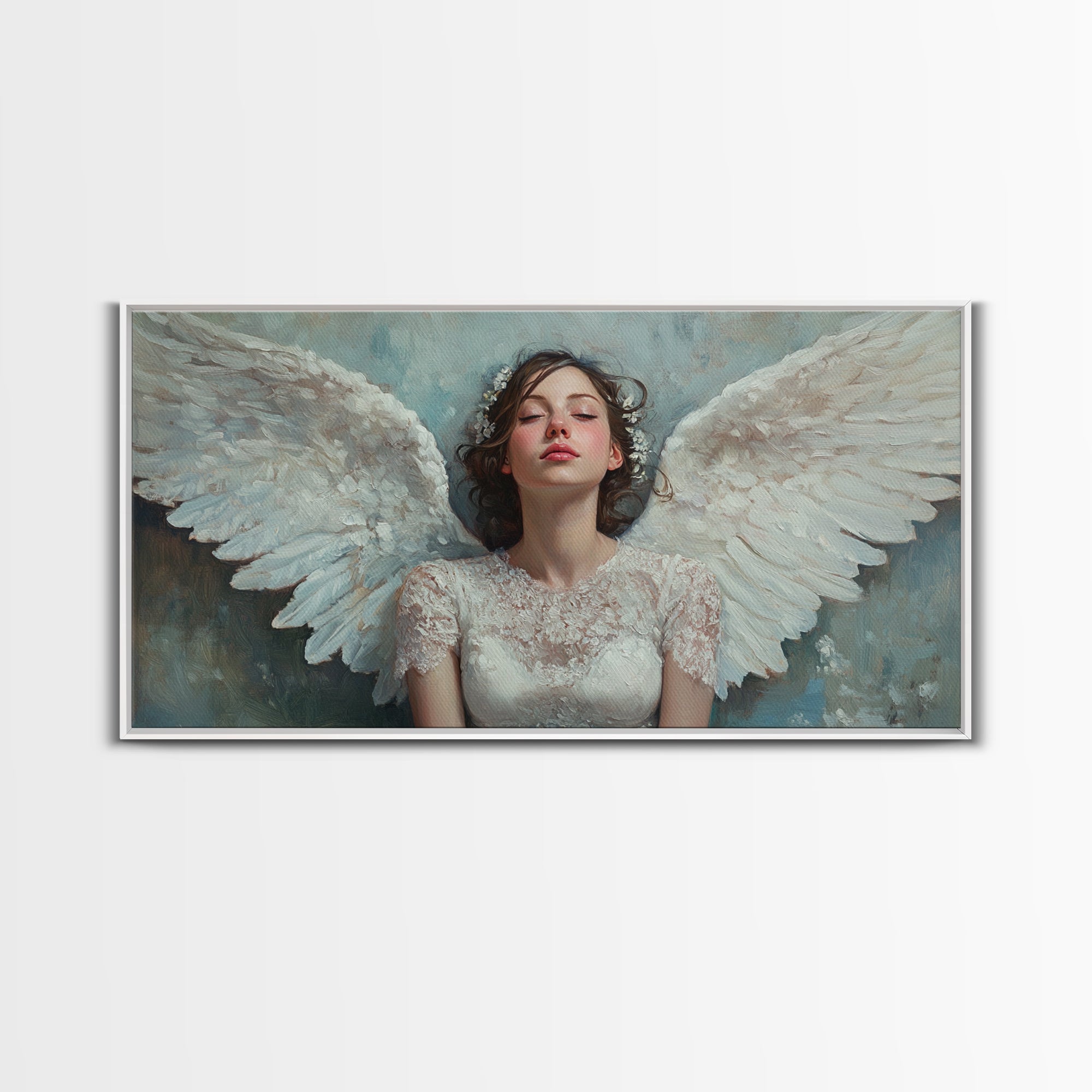 Framed angel canvas print with angel figure and white wings, silver frame