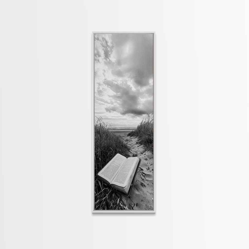 White framed canvas print of open Bible on a sandy beach path under cloudy sky