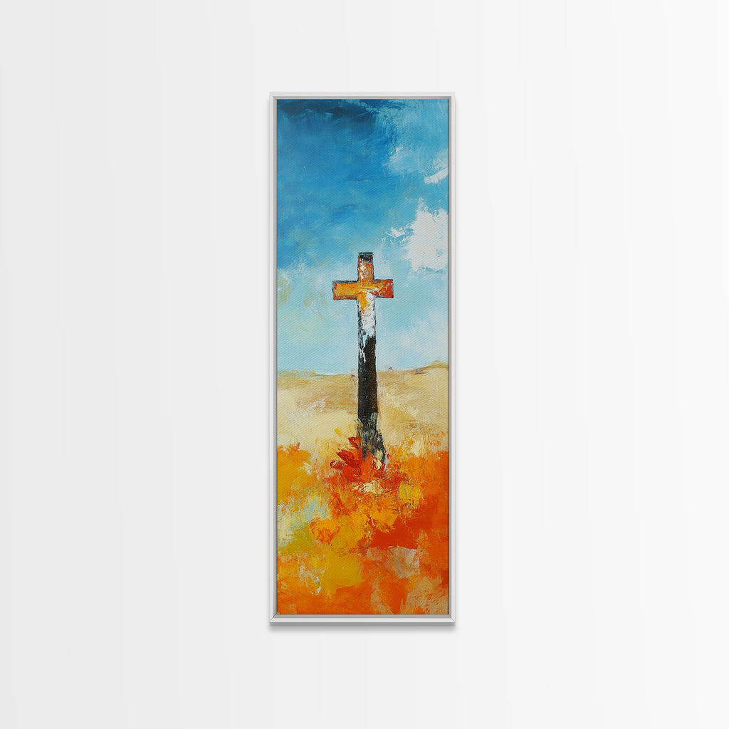 Framed canvas wall art with cross on blue sky and orange ground, light frame
