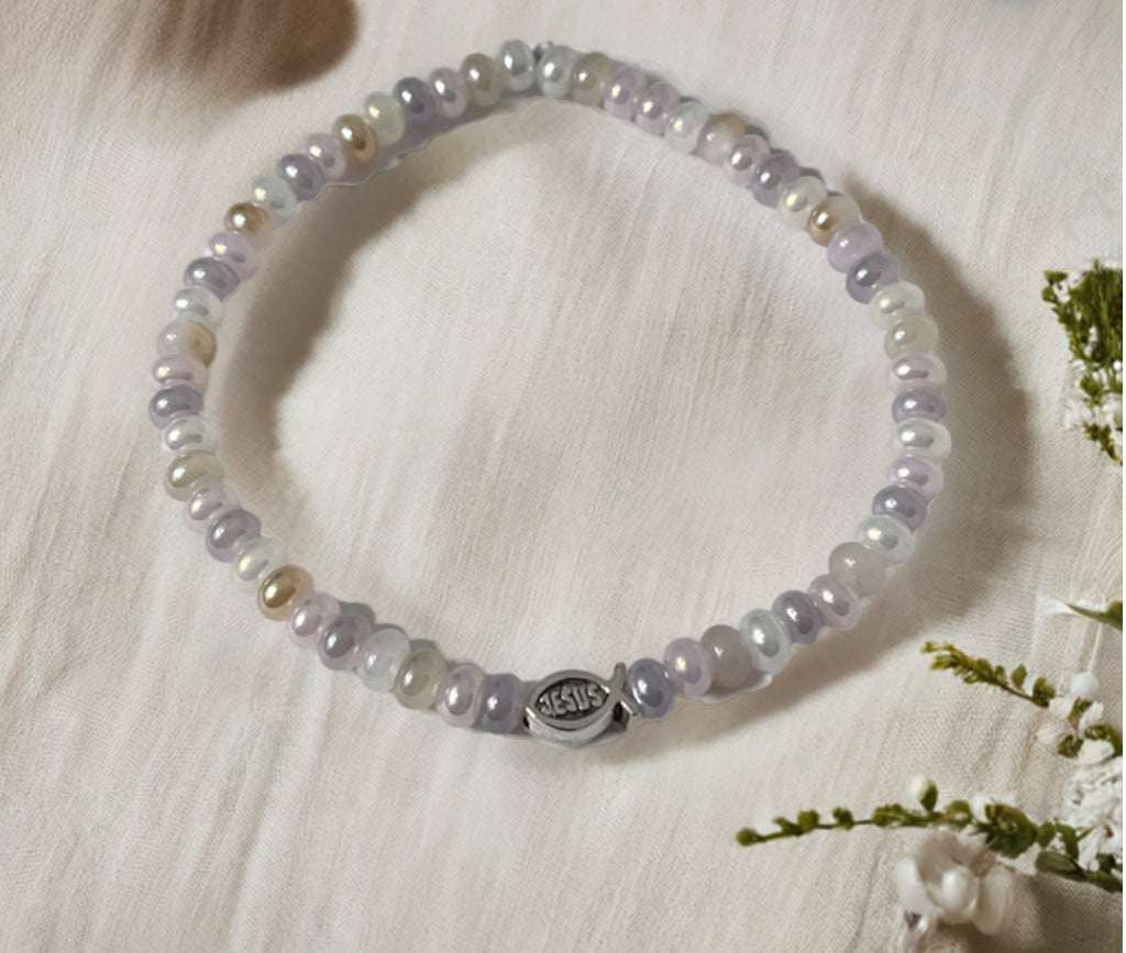 Bead bracelet with light purple glass beads and a small silver charm clasp
