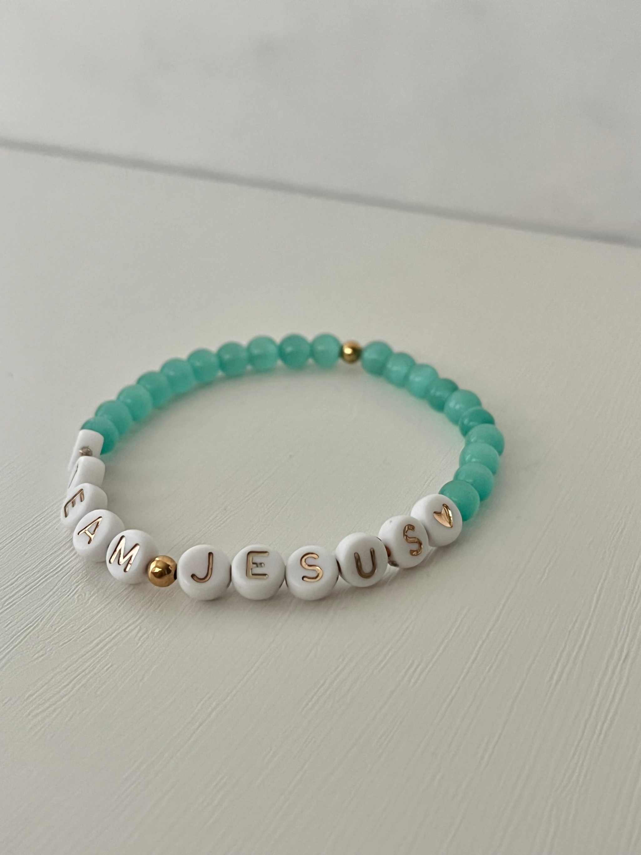 Teal iridescent beaded bracelet with white letter charms and gold spacer beads