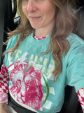 Teal t-shirt with red lion graphic and multicolor banner print