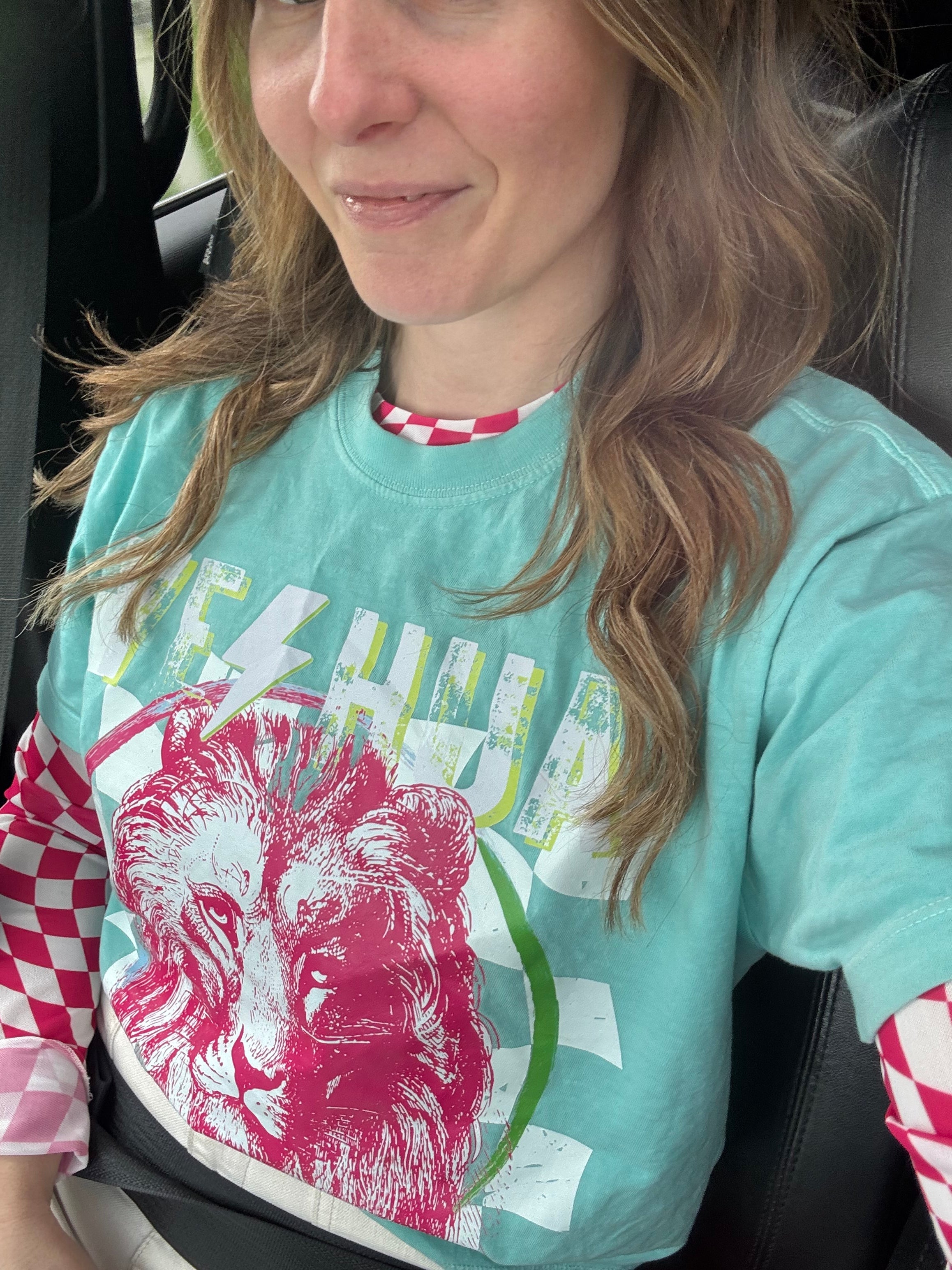 Teal t-shirt with red lion graphic and multicolor banner print