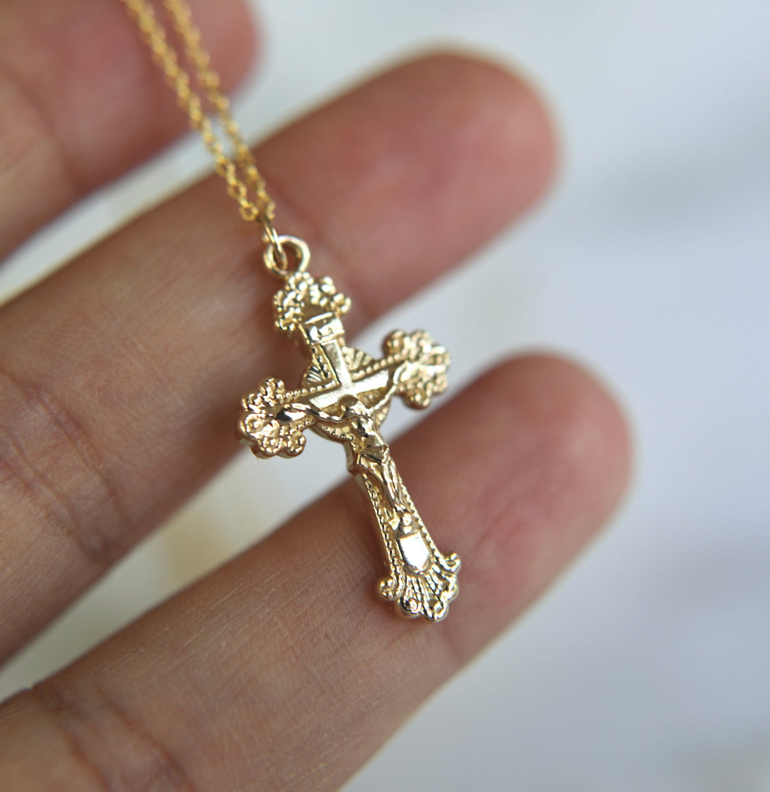 14k gold crucifix pendant on a link chain, detailed front cross charm.