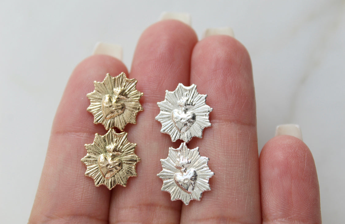 Assorted sacred heart stud earrings, gold- and silver-tone starburst medallions