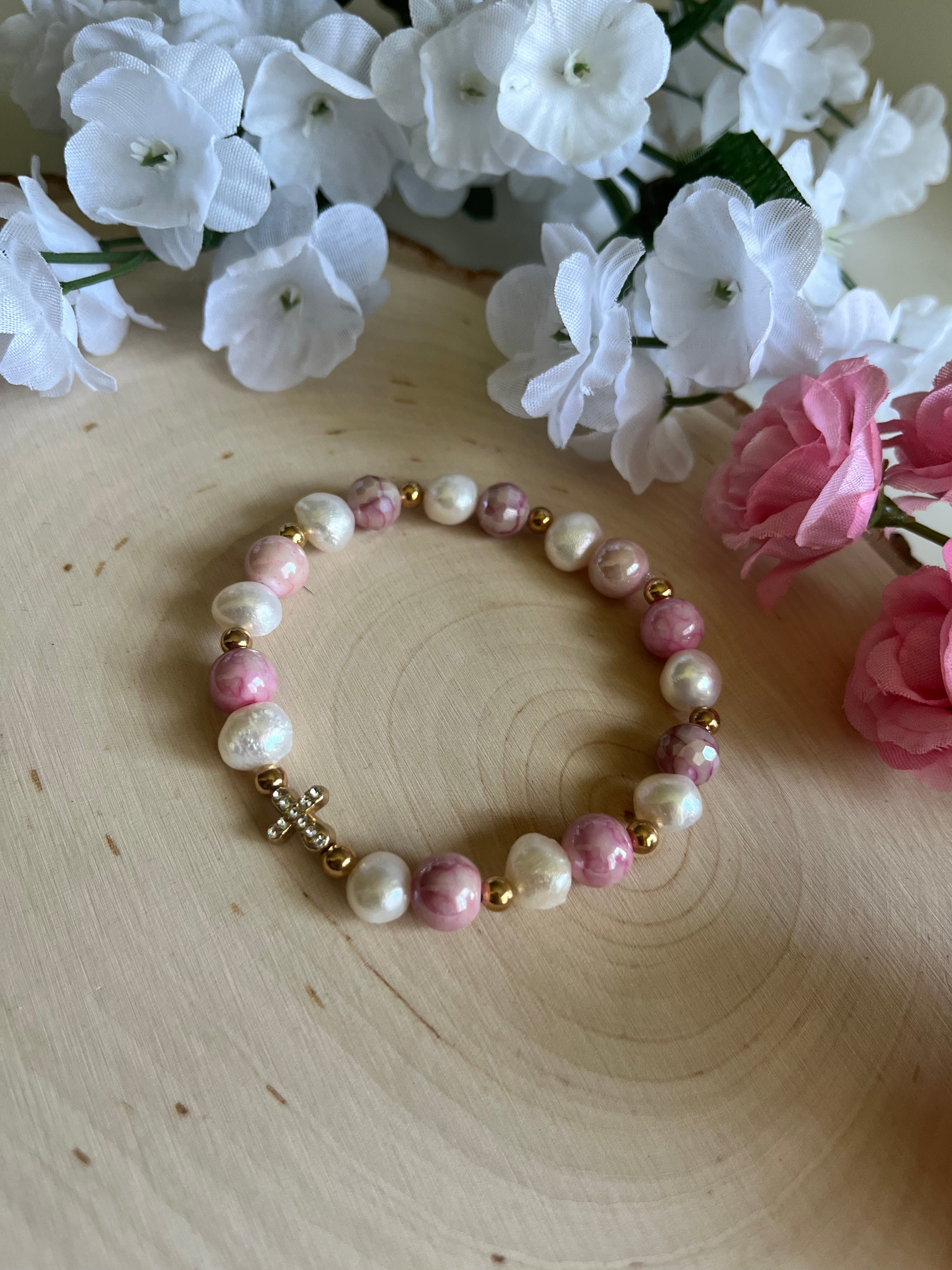 Pink and white pearl bead bracelet with gold cross charm and gold accents