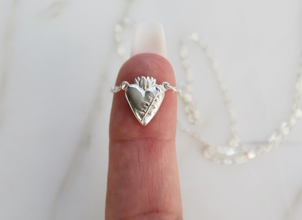 Sterling silver heart pendant necklace on a fine chain, heart face with raised relief