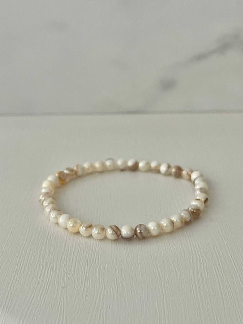 Freshwater pearl bead bracelet with round white pearls and light gold accents