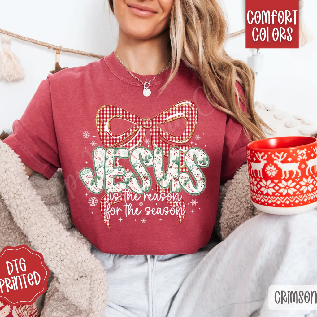 Maroon crewneck tee with red plaid bow and festive lettering graphic