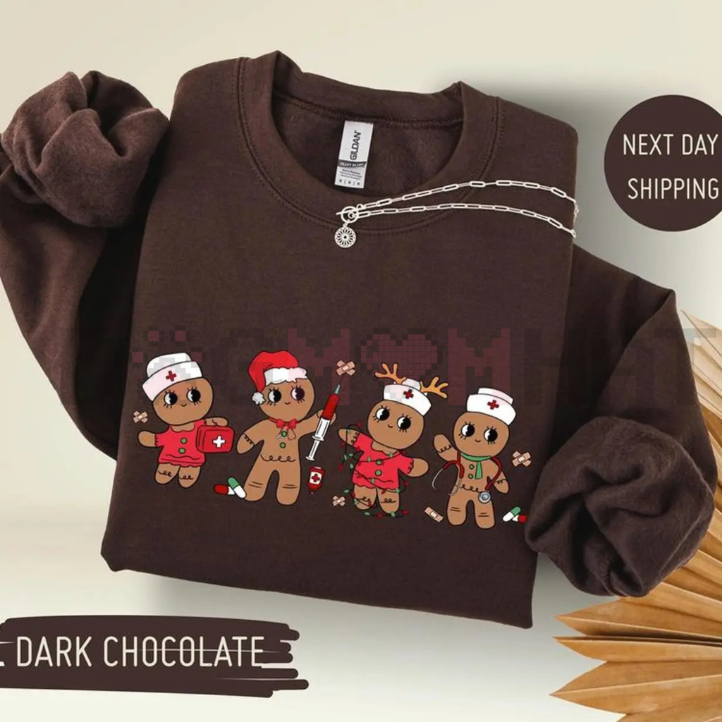 Dark chocolate sweatshirt with cartoon gingerbread nurse characters graphic on front, crew neck