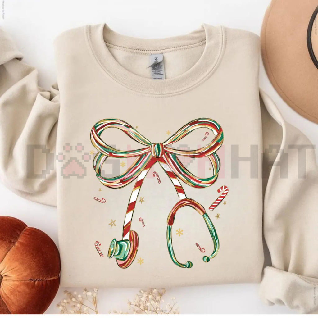 Cream Christmas nurse sweatshirt with colorful bow and candy cane graphic on front