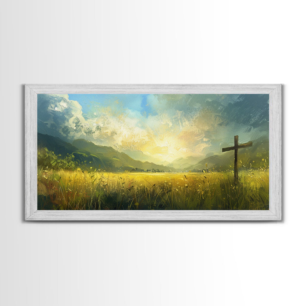 White framed canvas print with a cross in yellow-green grass and glowing sky