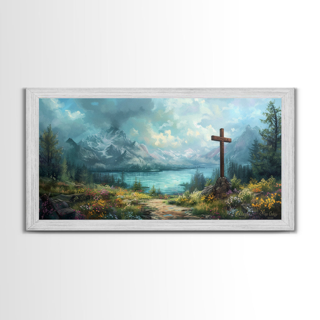 White framed canvas print of mountain landscape with a wooden cross by a lake path