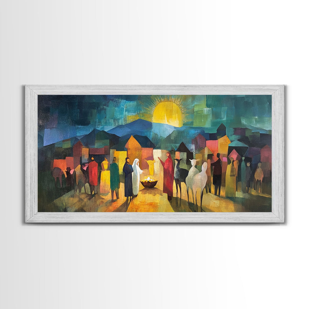 Silver-framed nativity scene wall art with village figures, glowing sun, and candlelight