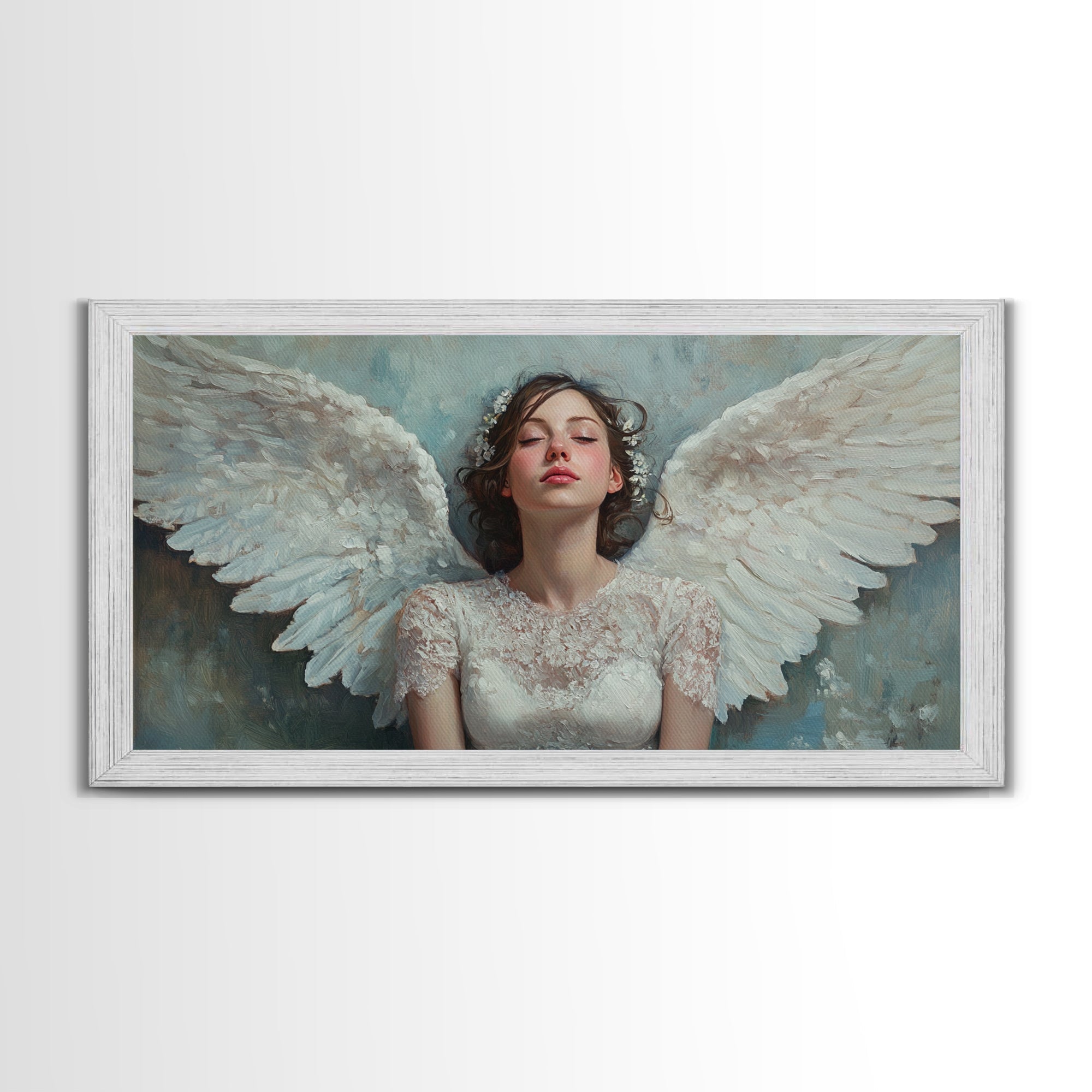 Framed angel canvas print with white wings and pale blue tones, white ornate frame
