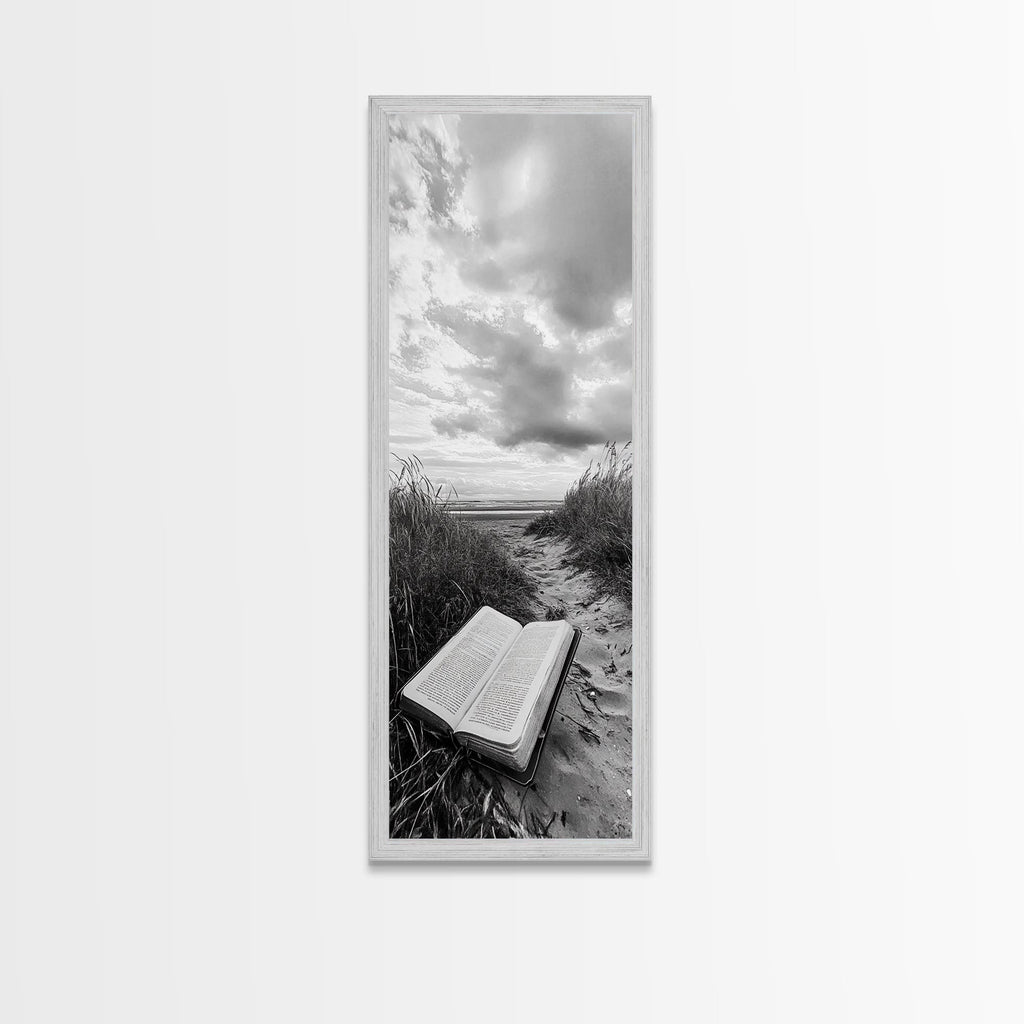 Gray framed canvas print of open Bible on a sandy beach path under cloudy sky