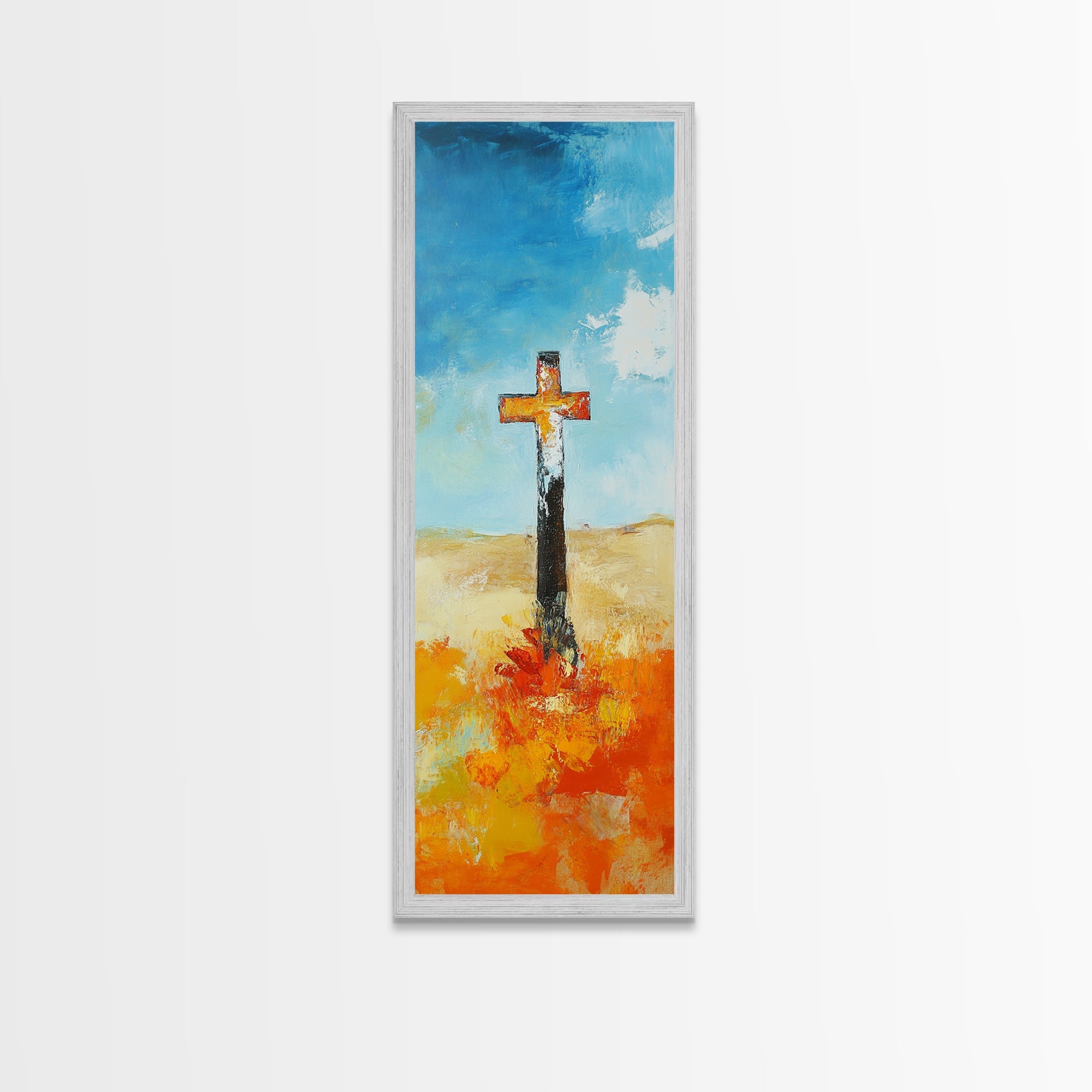 Framed canvas wall art with cross on blue sky and orange ground, silver frame