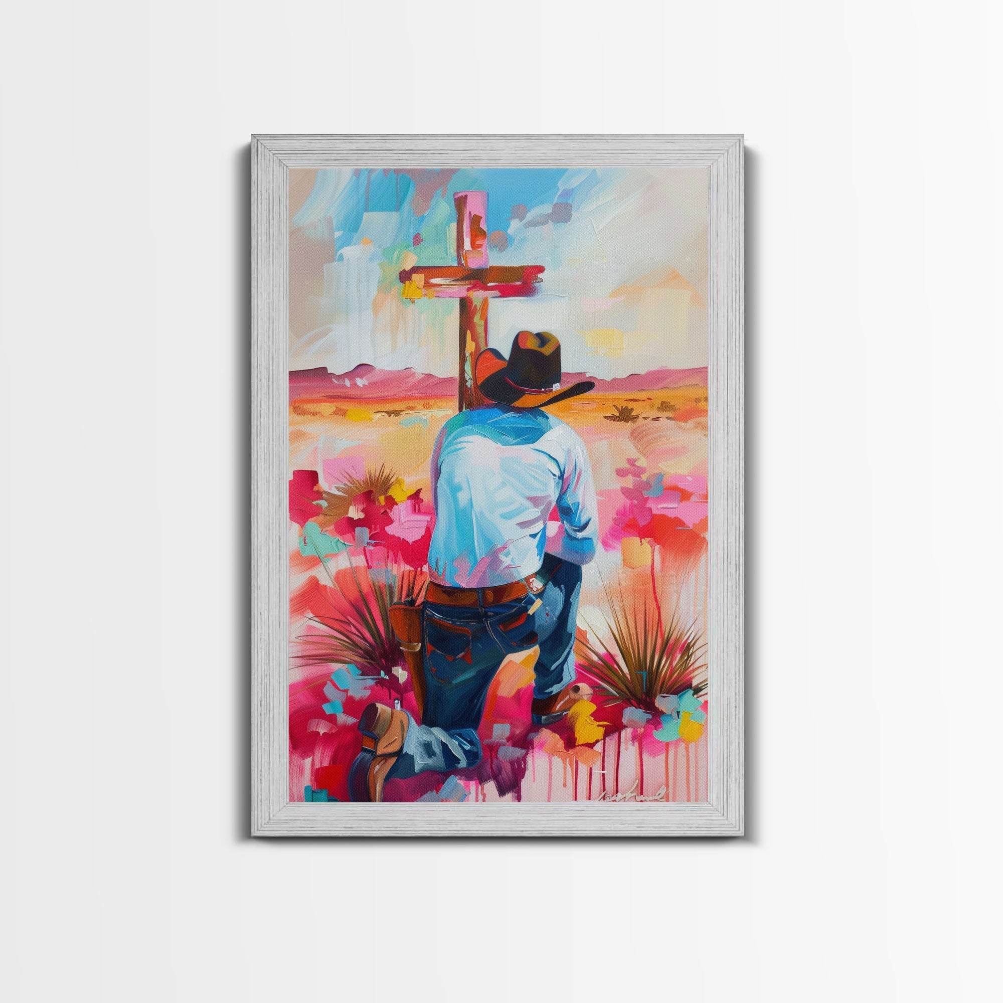Framed canvas print of a cowboy praying at a red cross in vibrant pink and blue tones