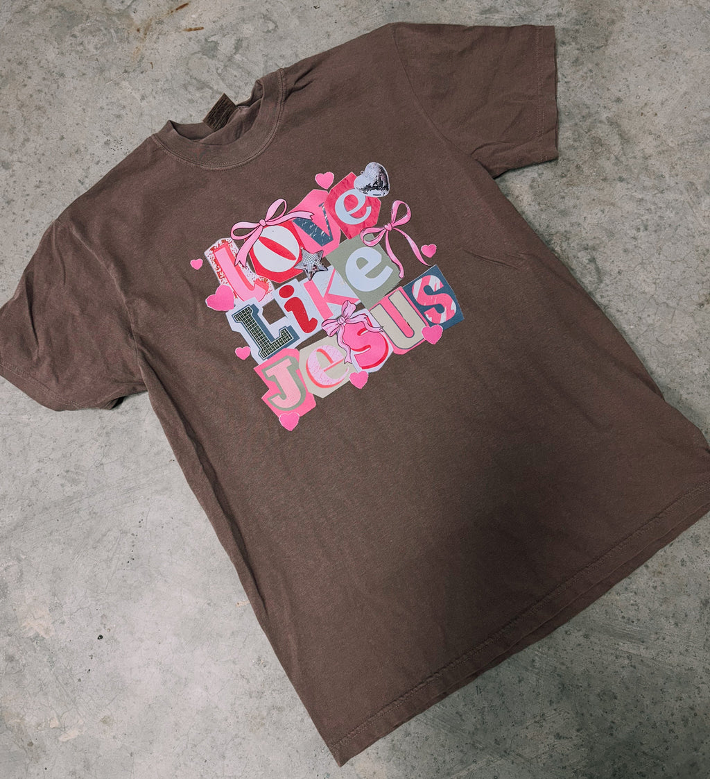 Dark brown short-sleeve graphic T-shirt with centered 'Love Like Jesus' text print