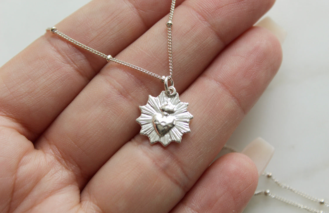 Sterling silver heart pendant necklace with scalloped frame on a fine chain