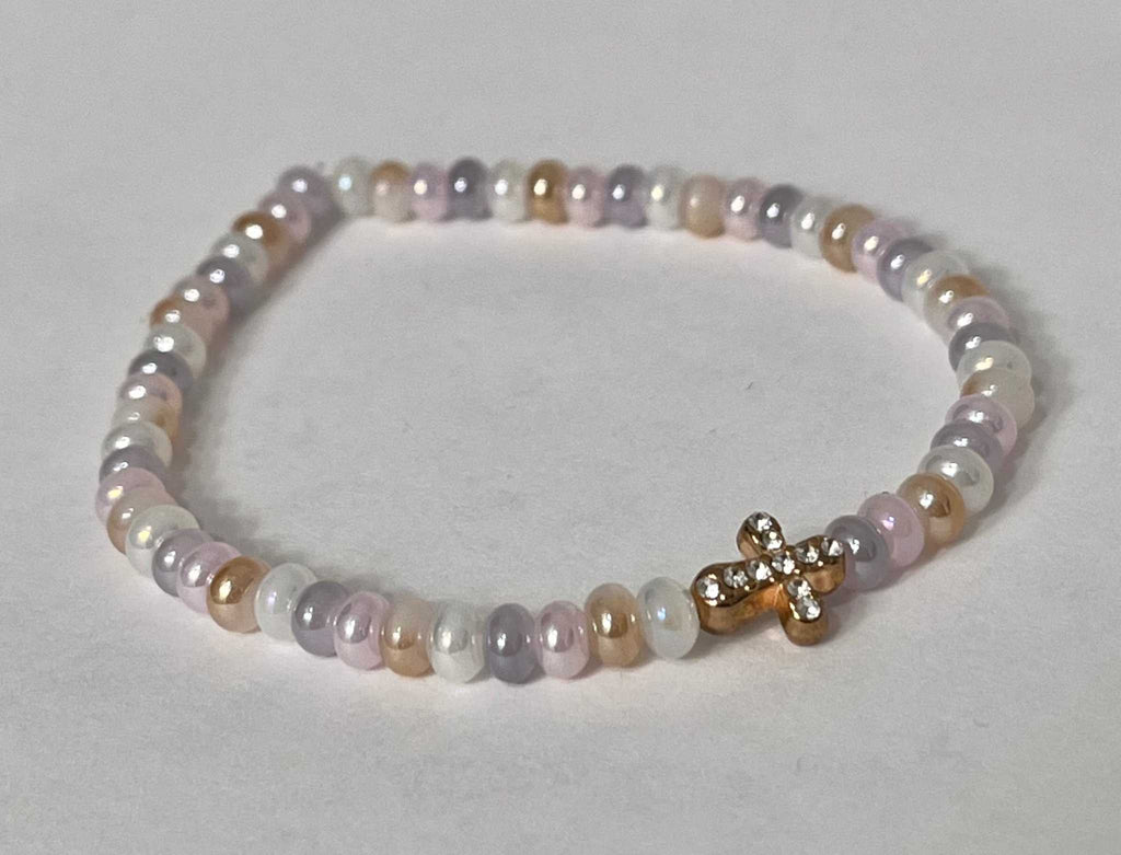 Bead bracelet with lavender and white oval beads and a gold cross charm